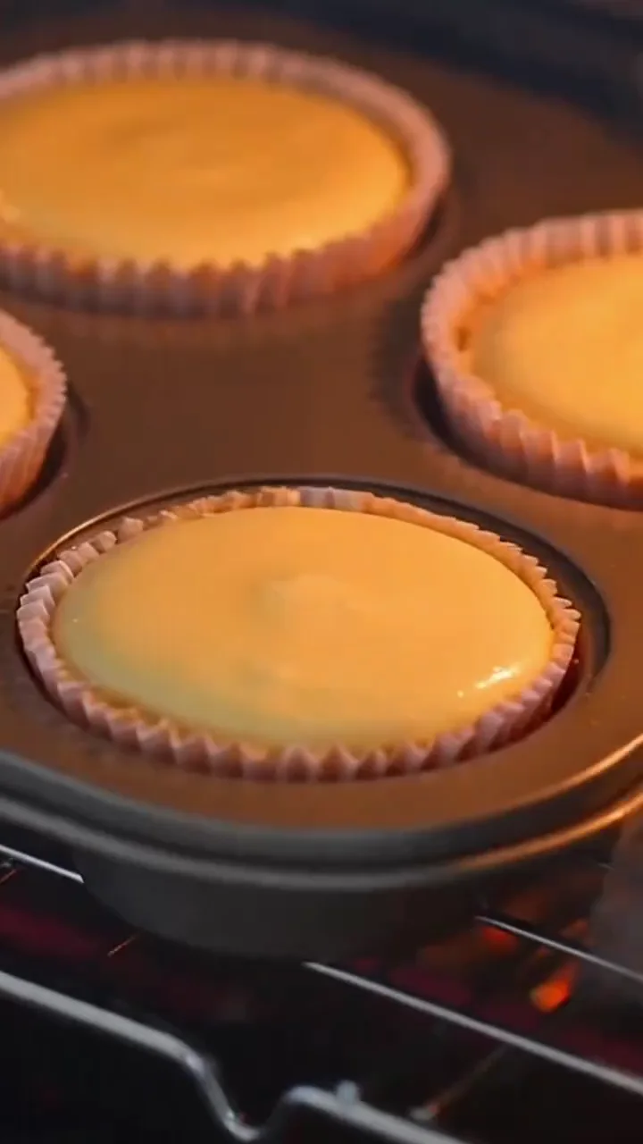 Mini lemon cheesecakes baking in a muffin pan