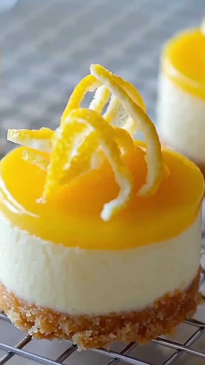Mini lemon cheesecakes garnished with lemon curls